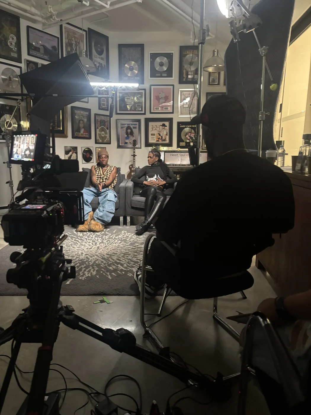 Behind-the-scenes filmed interview production with cameras and participants