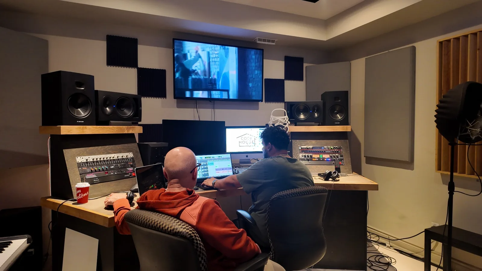 Professional studio control room with engineer working at console
