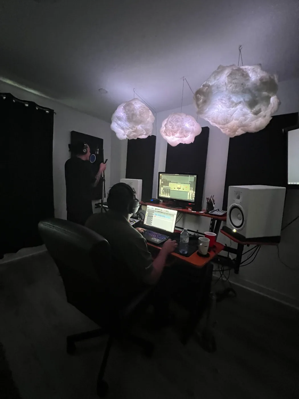 Audio engineer at a recording workstation during a studio session